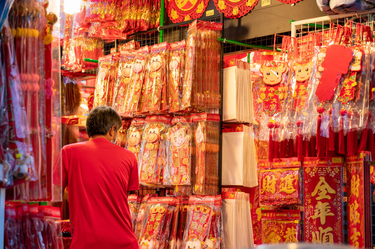 Person Shops In A Store Selling Red And Gold Decorations