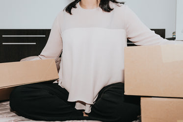person sitting with large cardboard boxes