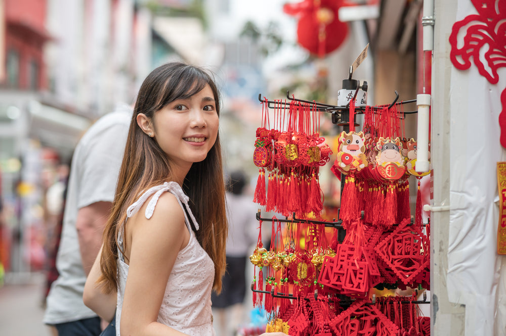 person smiles while shopping at a outdoor market