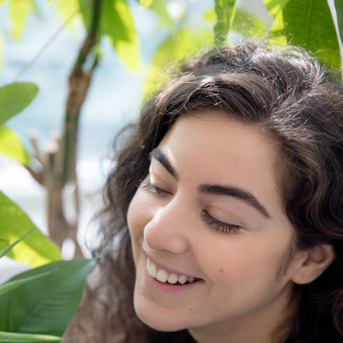 Person Smiling While Looking At Plants