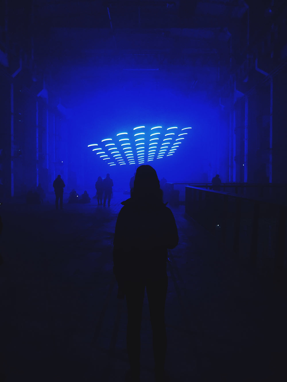 person standing in dim blue room