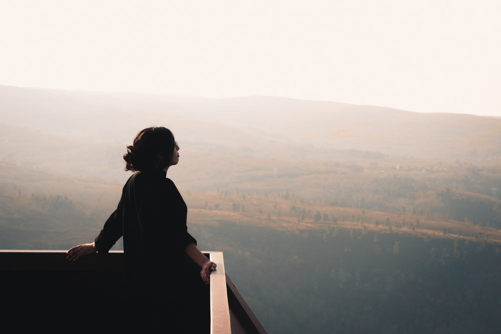 person stands at a lookout and takes in the vista