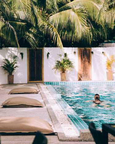 person swimming in clear pool