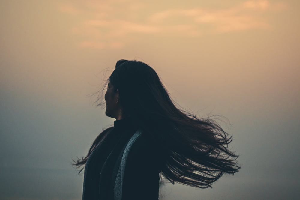 person tosses their hair away from frame