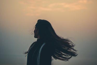 person tosses their hair away from frame