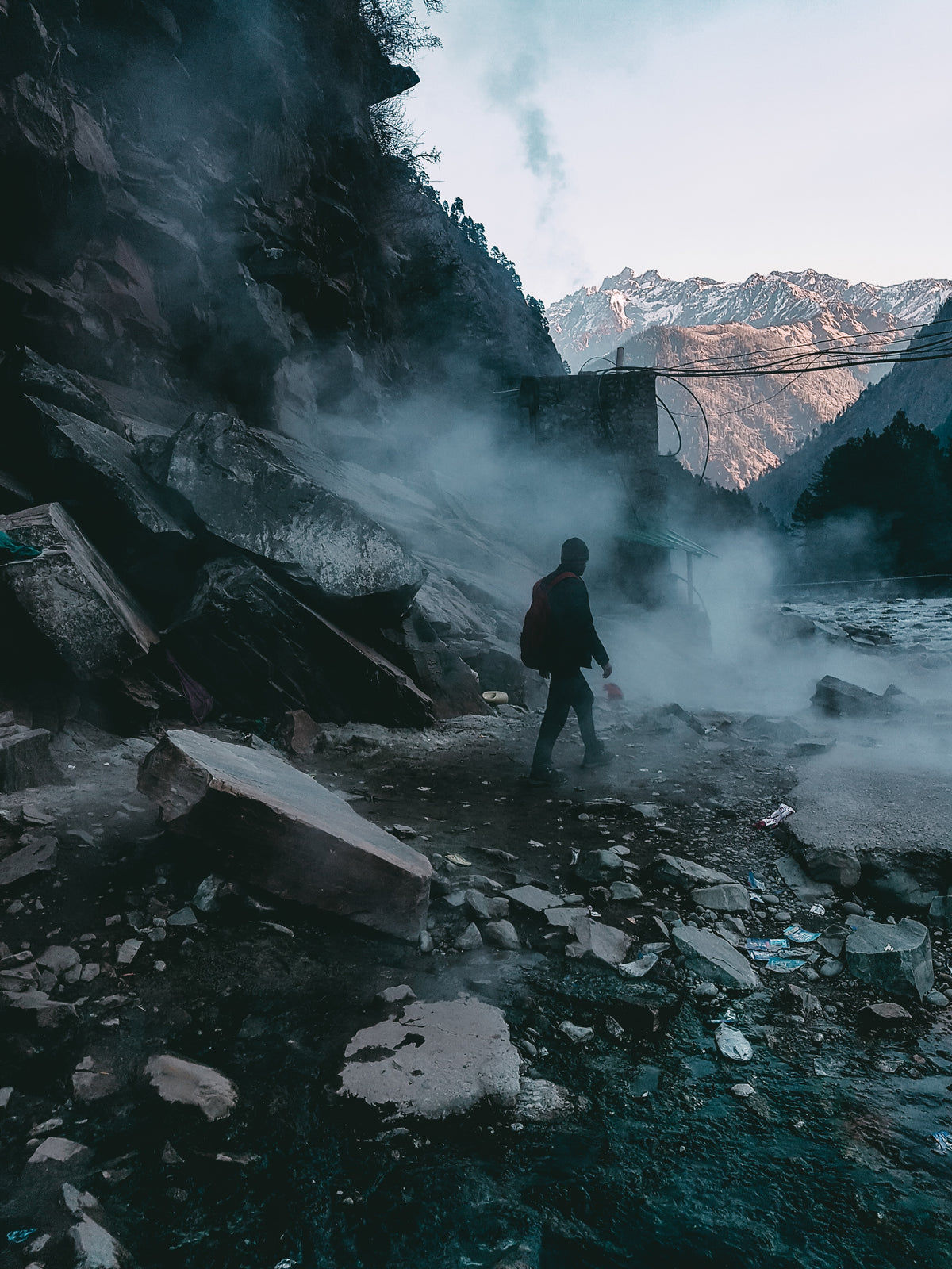 person treks foggy mountain and river terrain