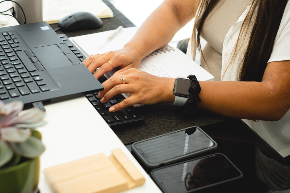 Person Typing Away With Both Hands On A Keyboard