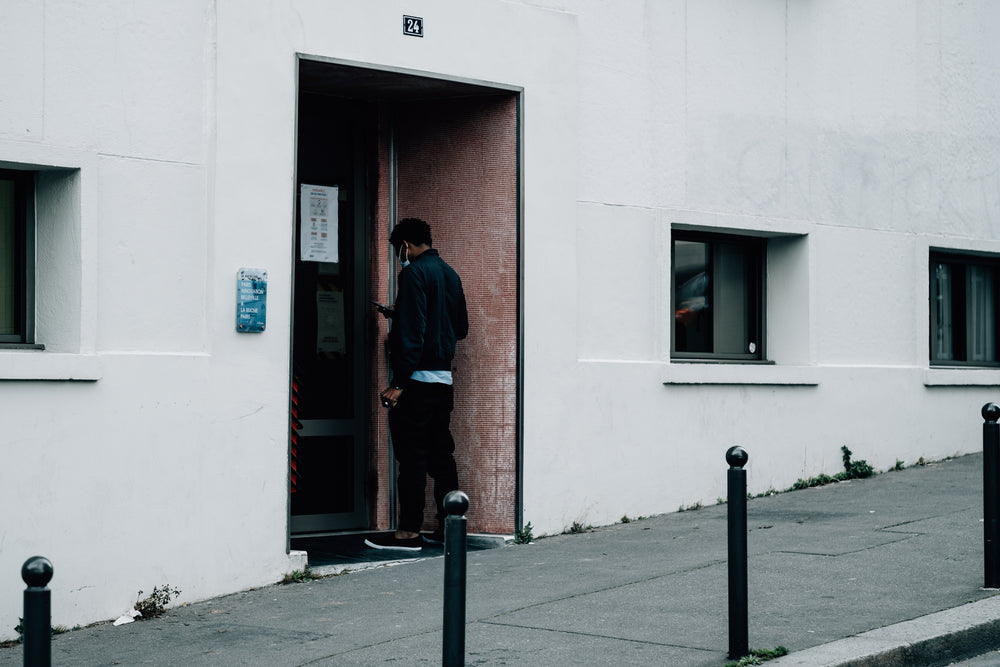 person waiting to enter at a building entrance