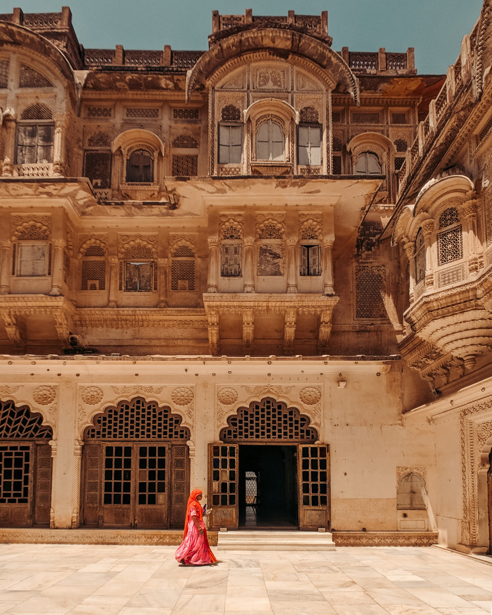 person walks in a open air courtyard