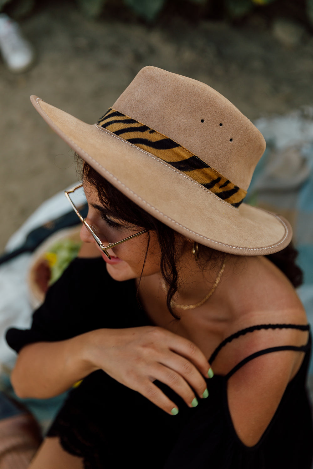 person wearing a suede hat and black outfit