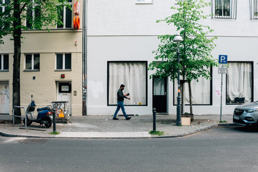 person wearing face mask walks down city street