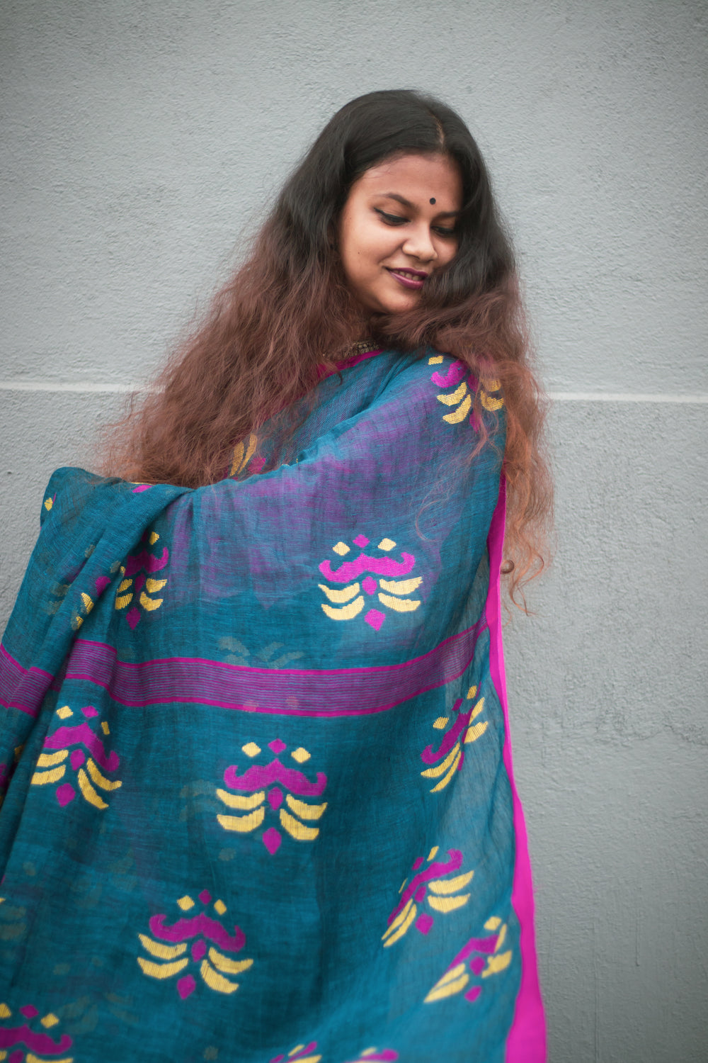 person with long brown hair wrapped in fabric