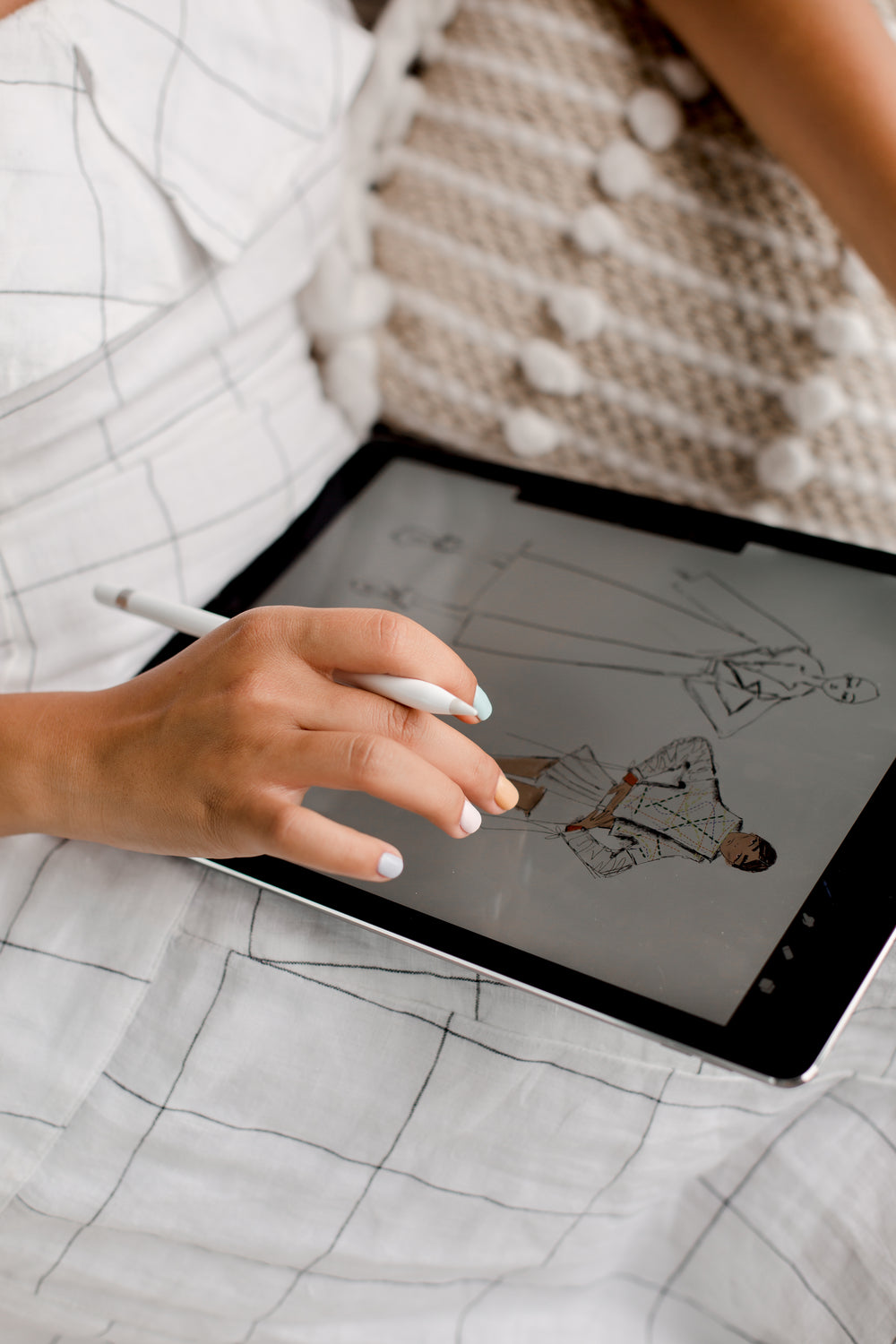 person working on fashion design on a tablet