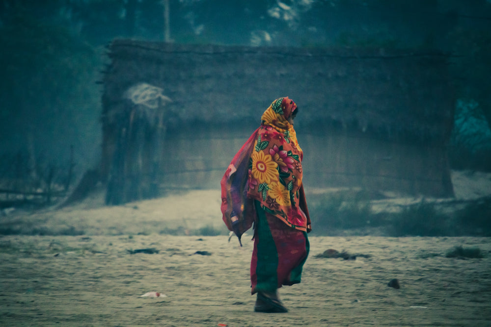 person wrapped in floral fabric walking