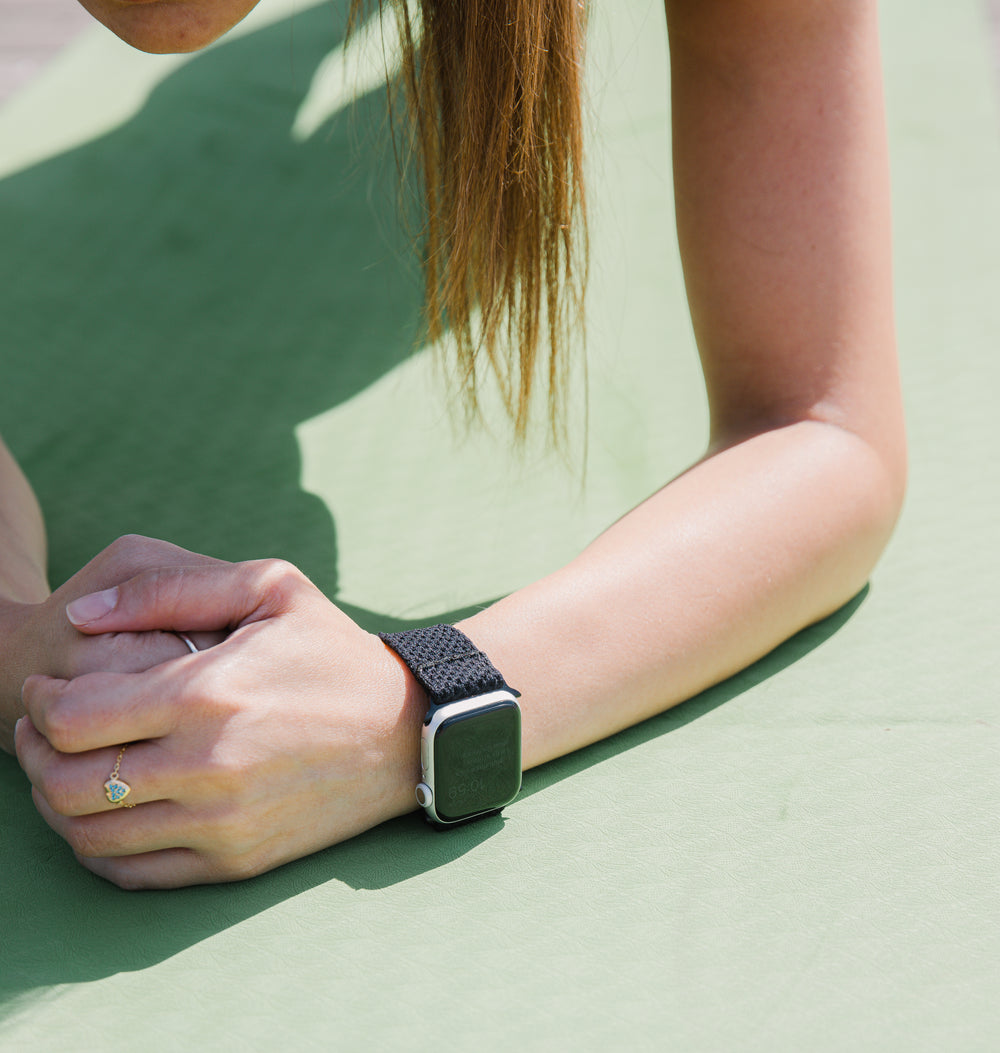 persons hand and arm on a green surface