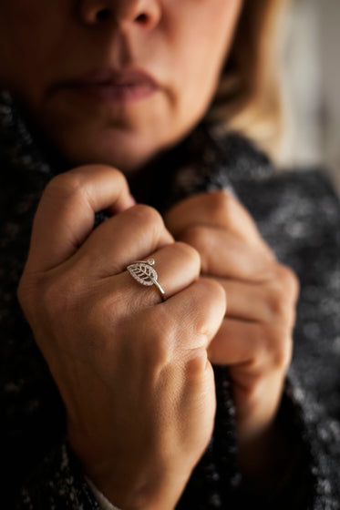 persons hands hold the collar of their sweater