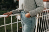 persons torso and jeans standing on a balcony