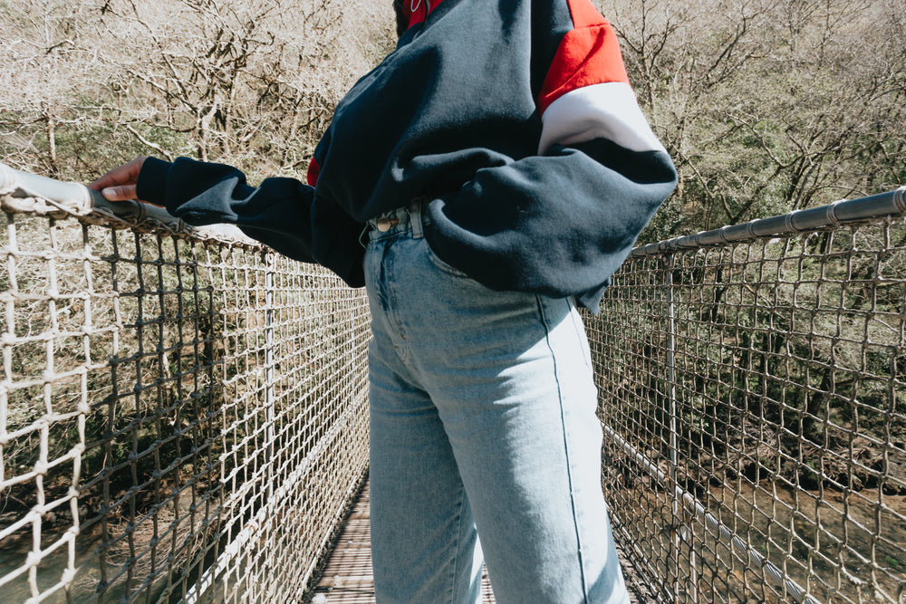 persons torso standing on a bridge above water