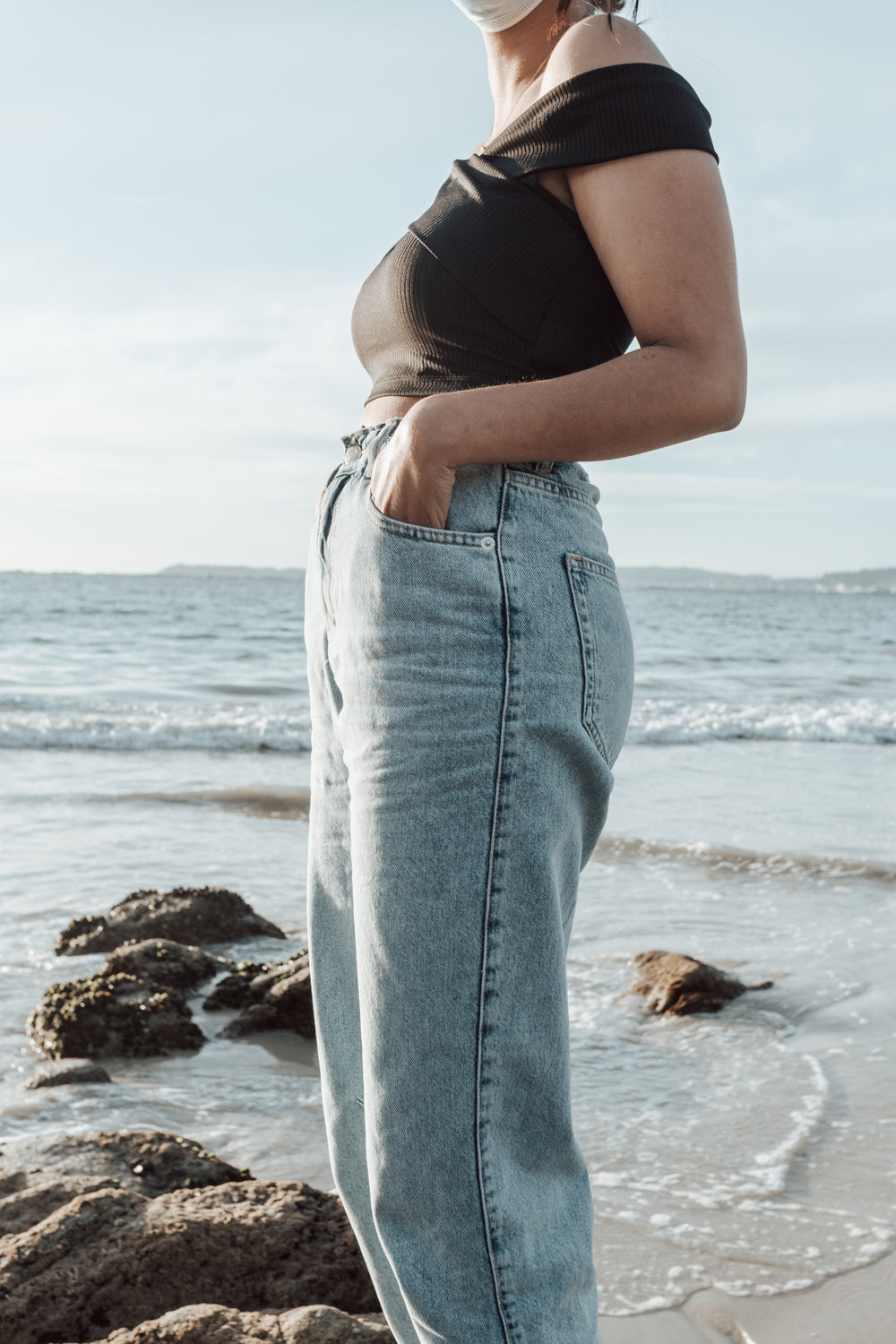 persons torso standing on a sandy beach