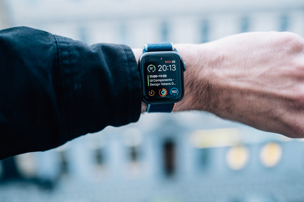 persons wrist wearing a smartwatch which shows the date