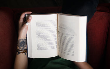 photo in first person perspective of a person reading a novel