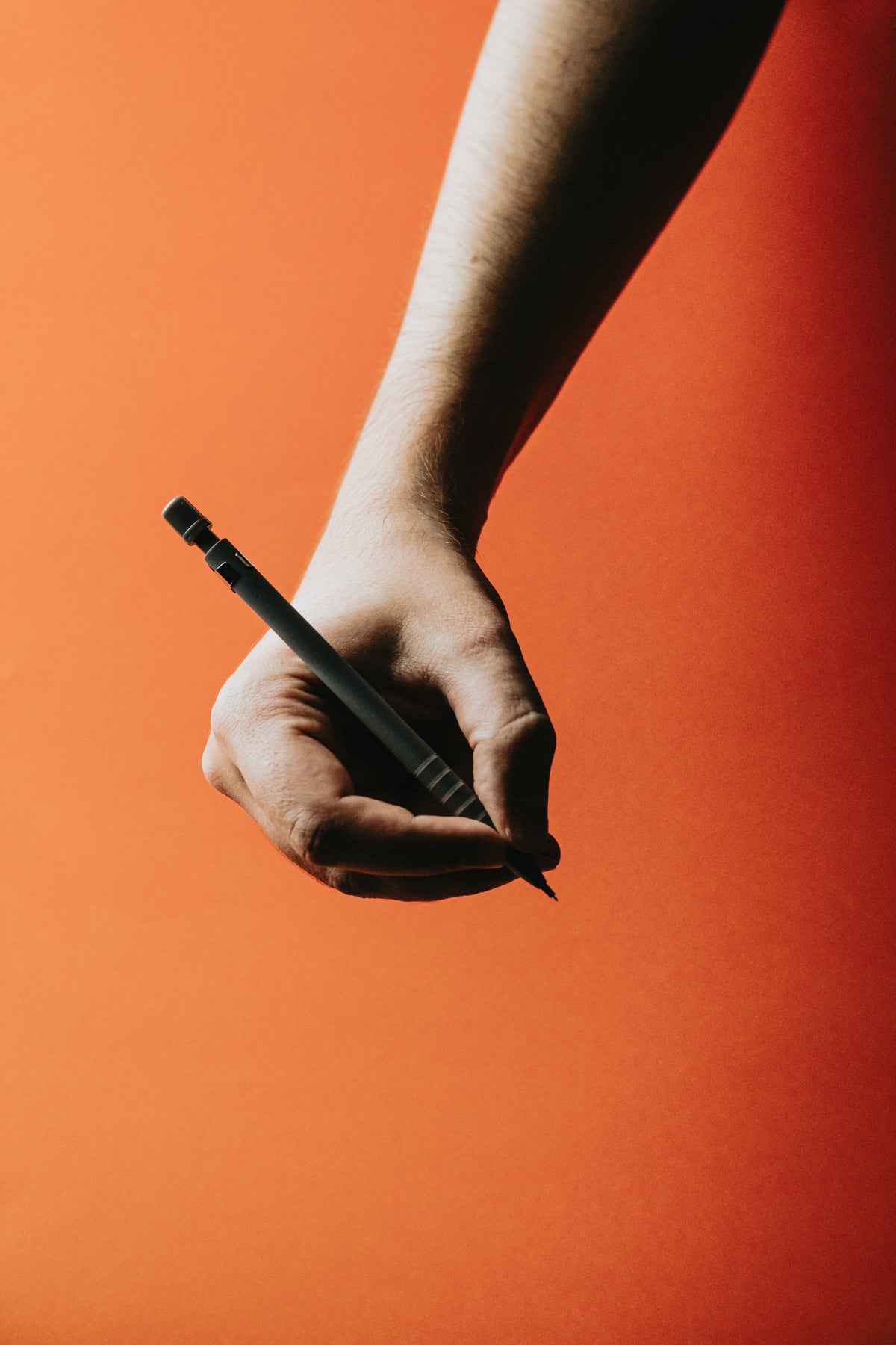 photo of a hand holding a pen
