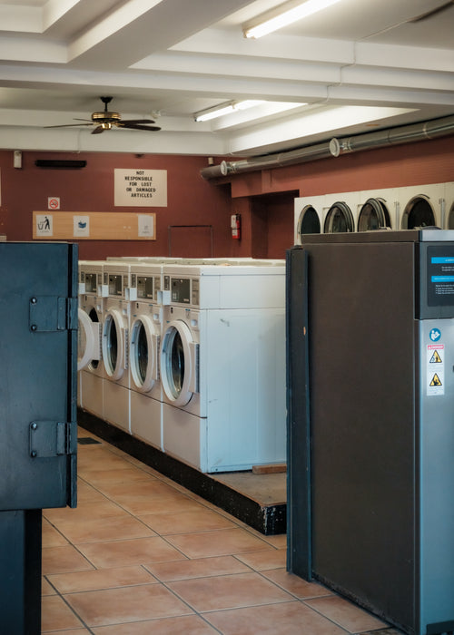 photo of a laundromat with red walls and white ceilings