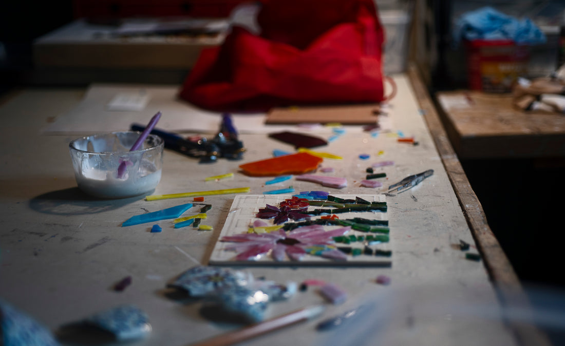 A mosaic artist's workstation covered in cut glass