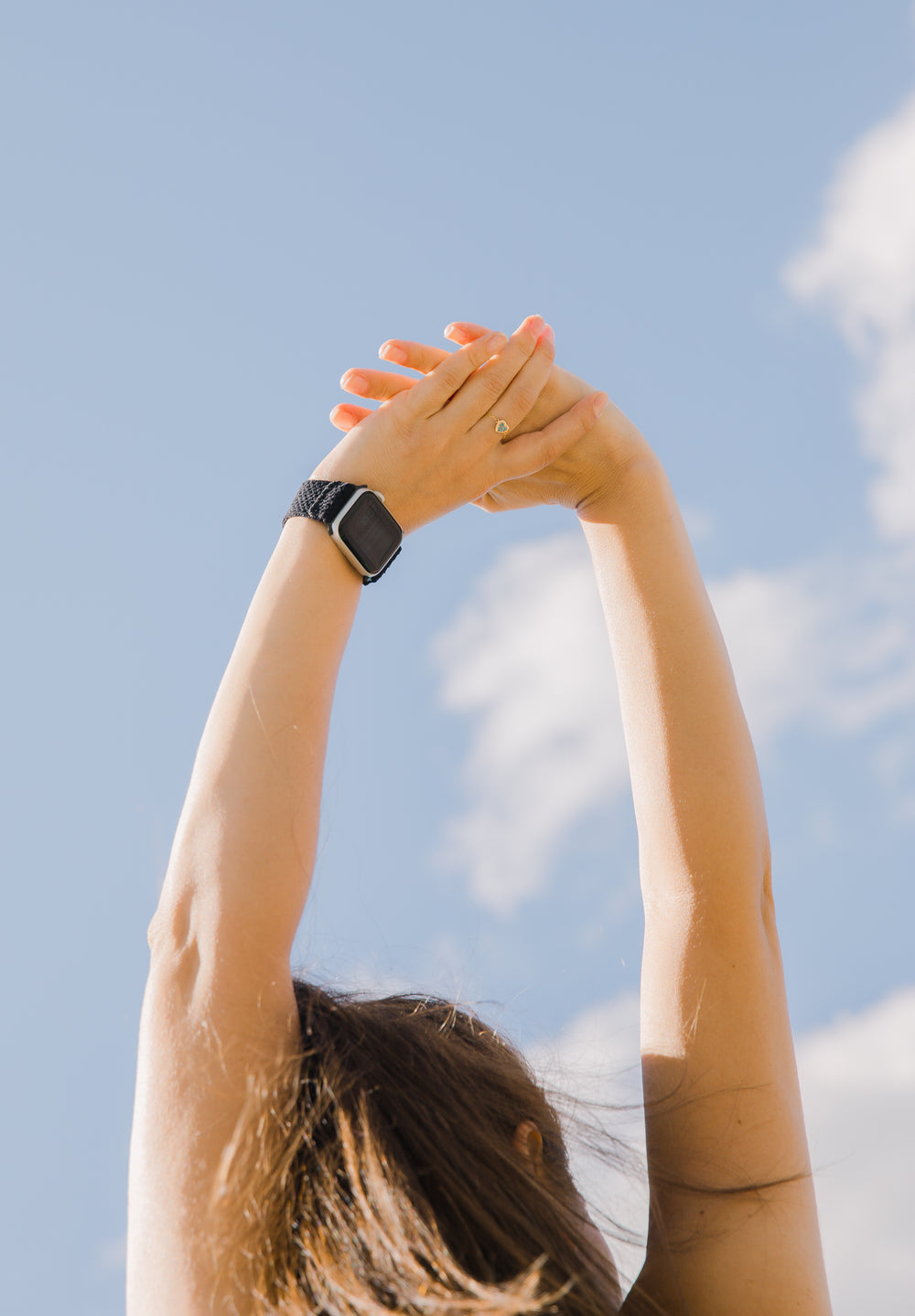 photo of a person reaching towards the sky