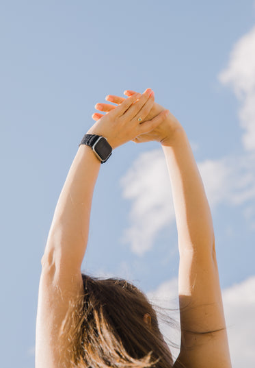 photo of a person reaching towards the sky