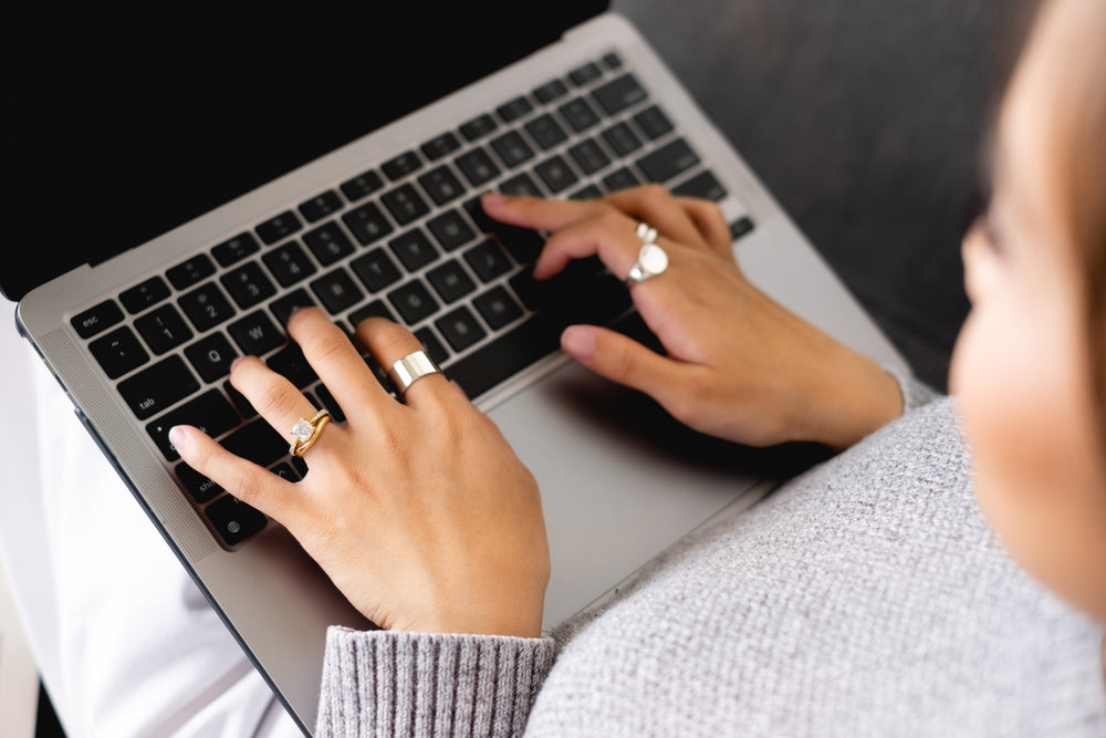 photo of a person typing on their laptop