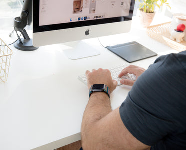 photo of a person working at their white desk