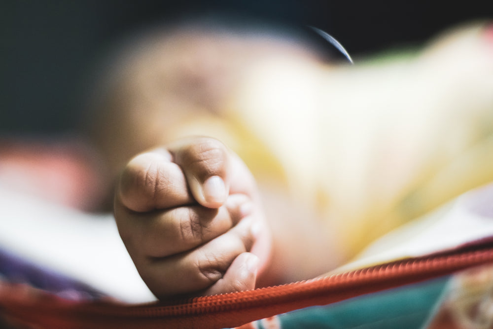 photo of a toddler with small clenched fist