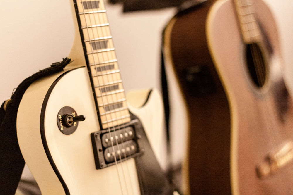 photo of an electric and and acoustic guitar