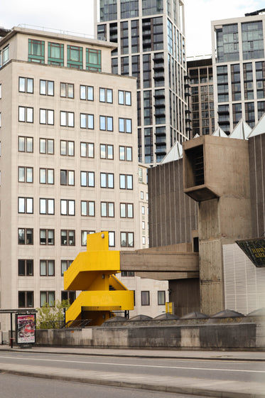 photo of city buildings and a yellow staircase