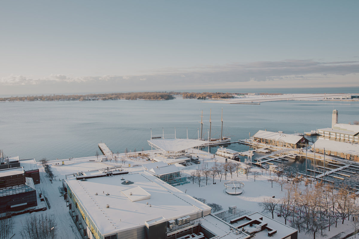 photo of snow covered buildings by a harbour
