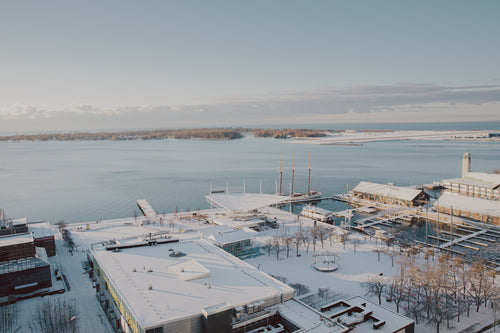 photo of snow covered buildings by a harbour