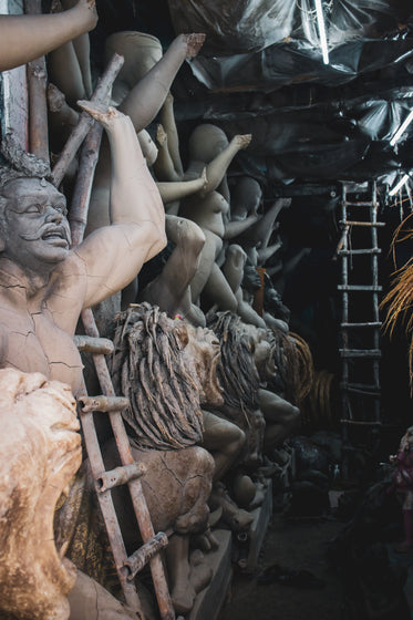 photo of wooden ladders and weathered sculptures