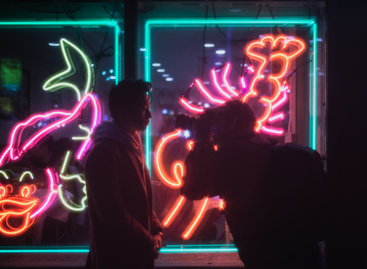 photographer and model in neon light