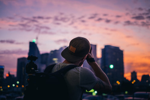 photographer shooting city sunset