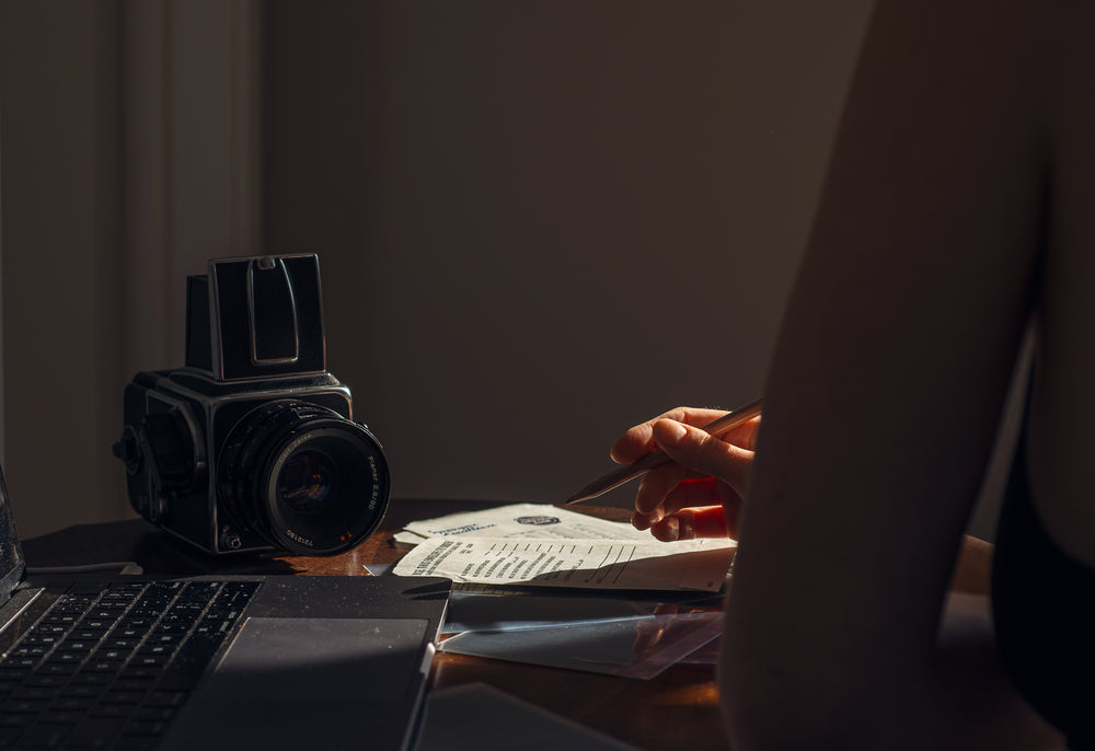 photographer sits at there desk and takes notes