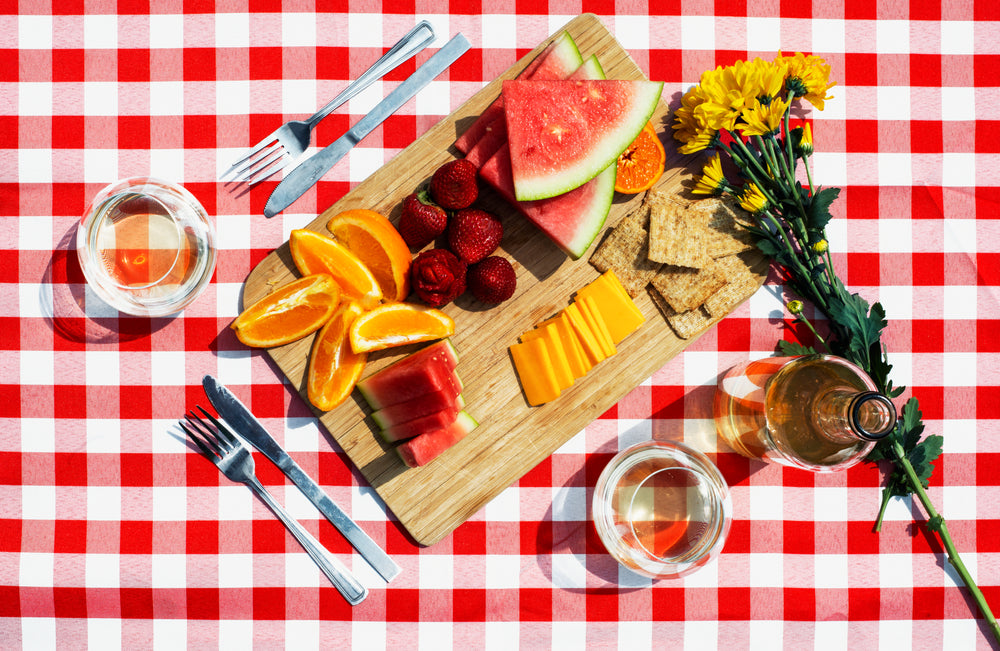 picnic snacks wine and flowers