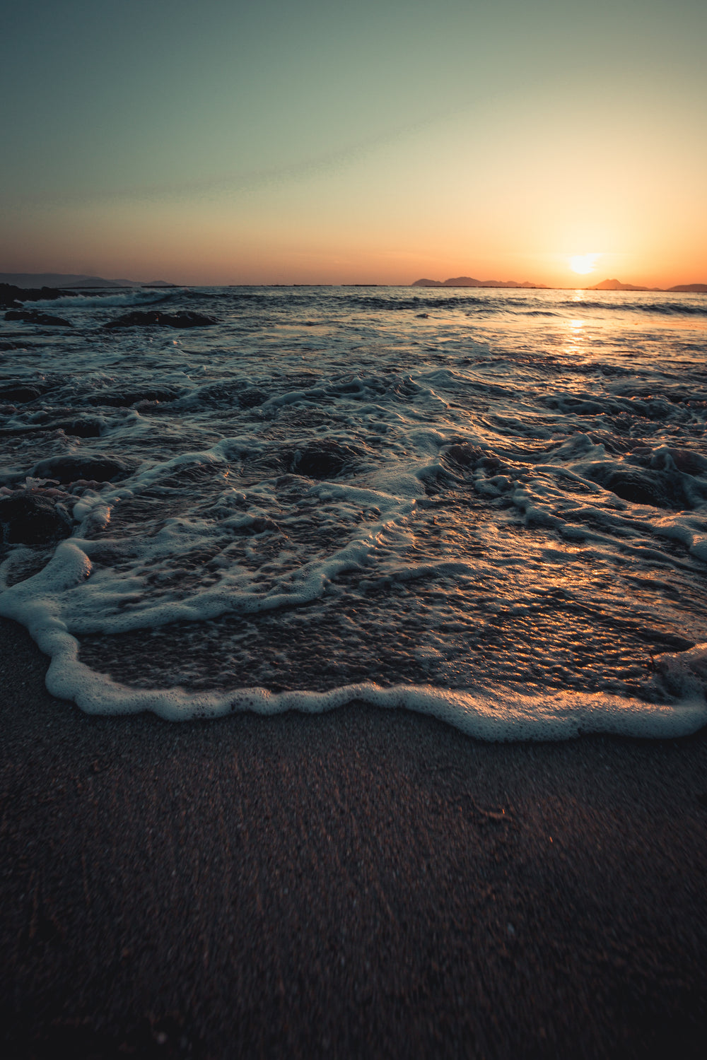 picturesque tide rolling below a sunset