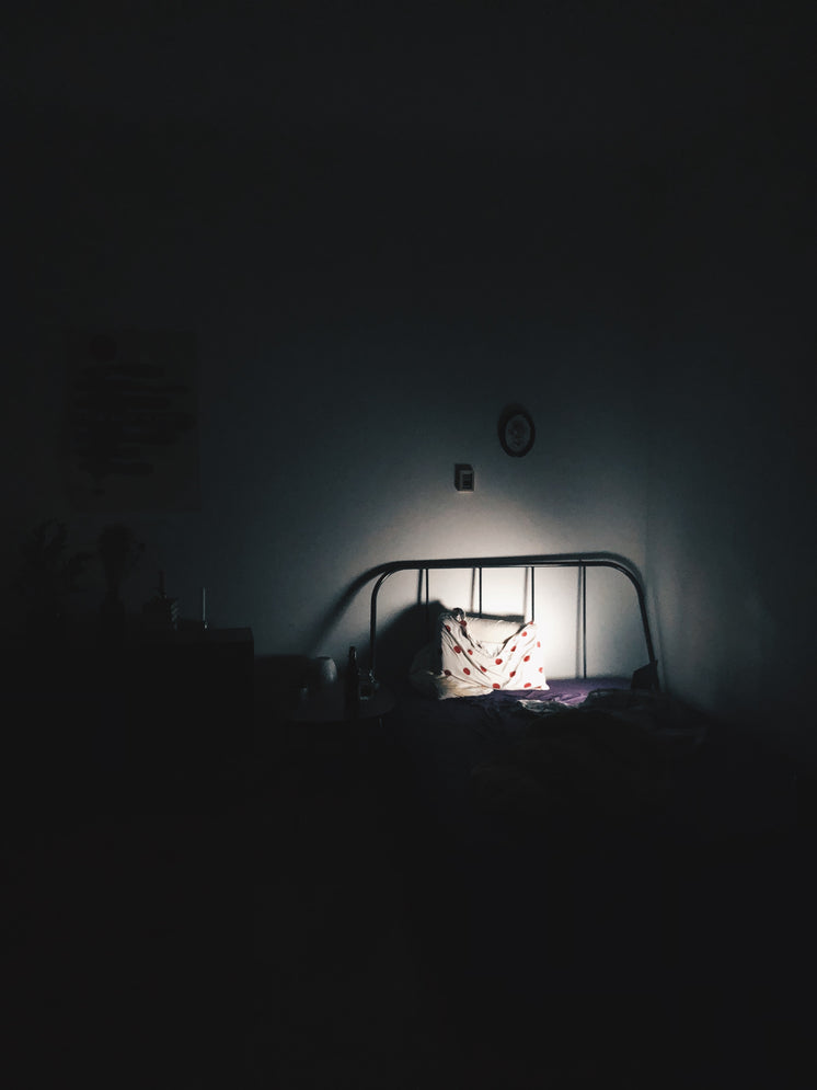 Pillow On Bed In A Dark Room