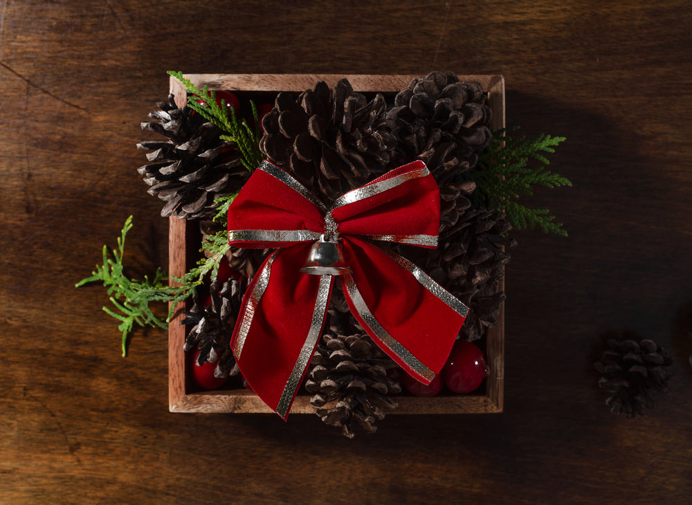 pine cones topped with a red bow