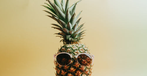pineapple with pink rimmed sunglasses