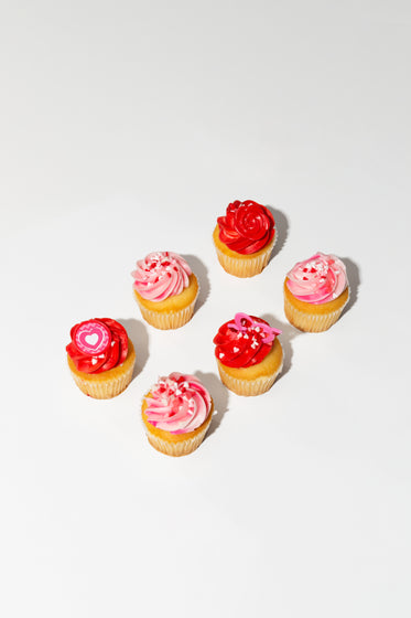 pink and red cupcakes on a white background