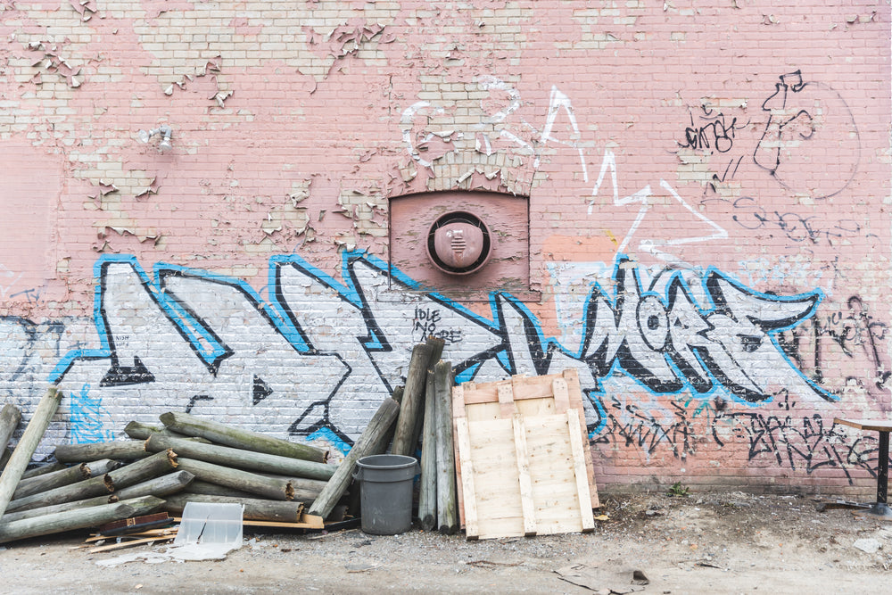 pink brick wall back alley wood pile