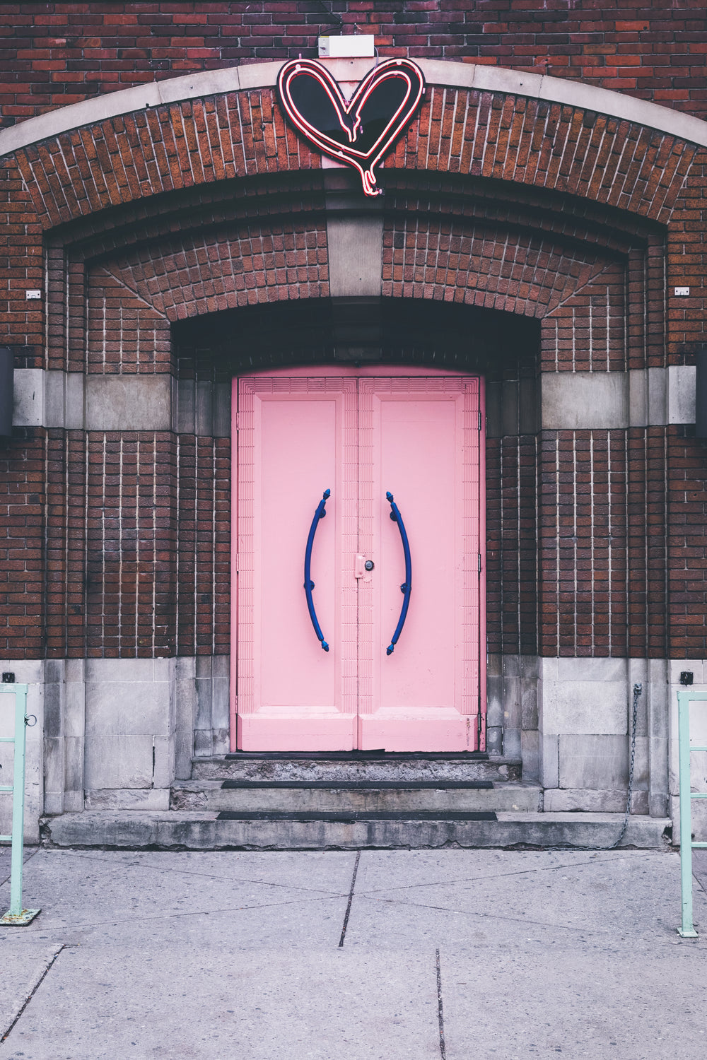 pink church doors with neon hard above