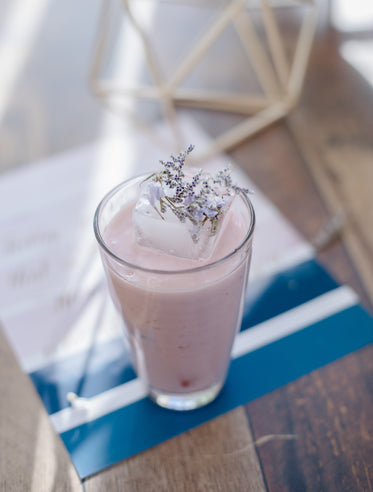 Pink Drink With A Large Ice Cubes And Flowers